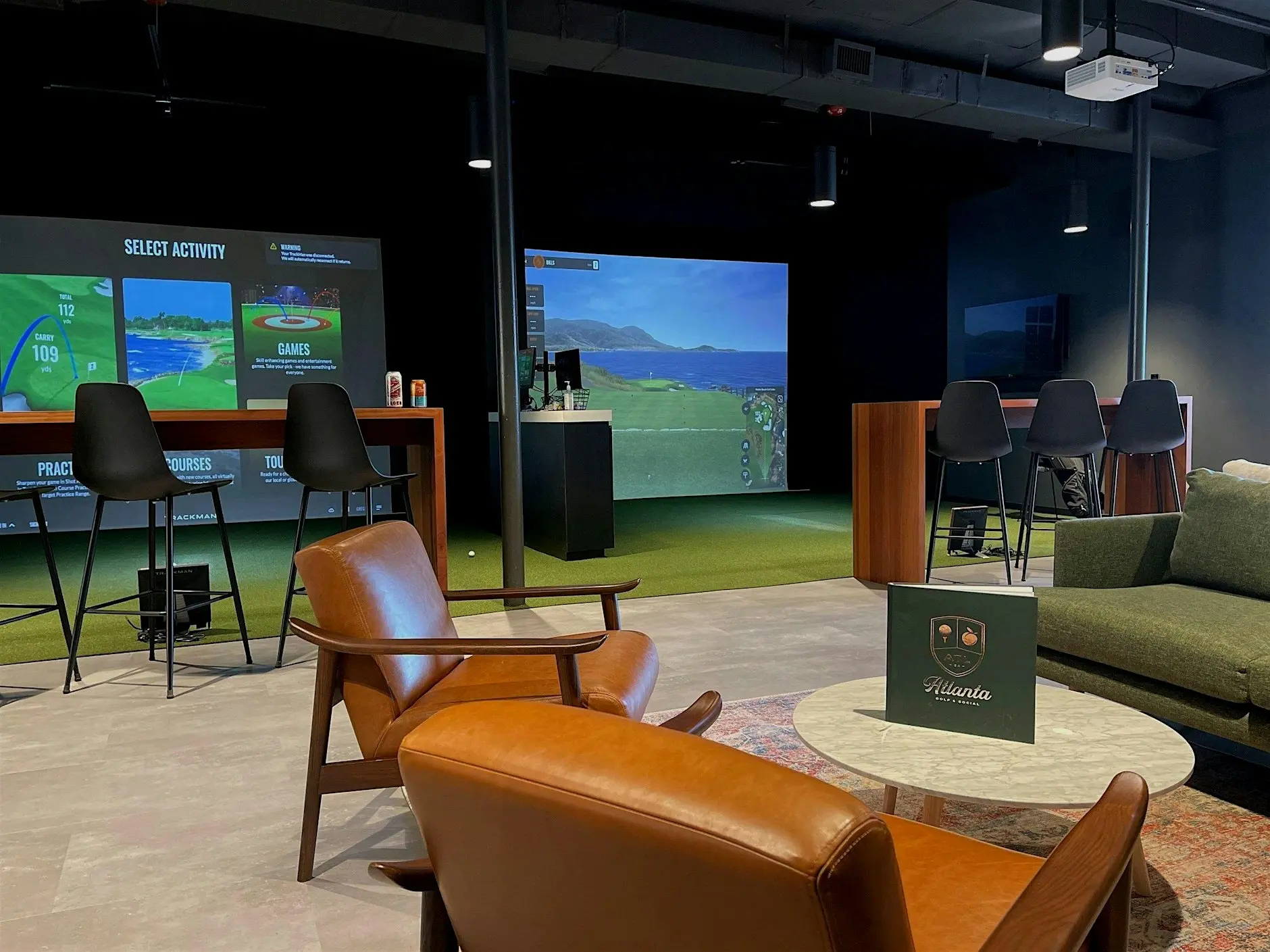 Indoor golf lounge with seating and simulators